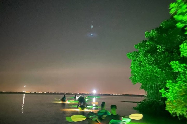 a man standing next to a body of water