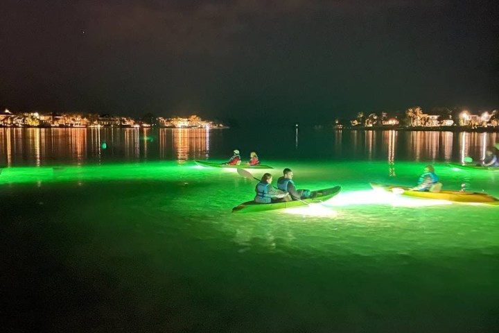 a body of water with a city in the dark