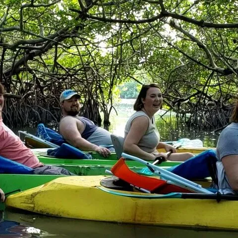 a group of people riding on the back of a boat