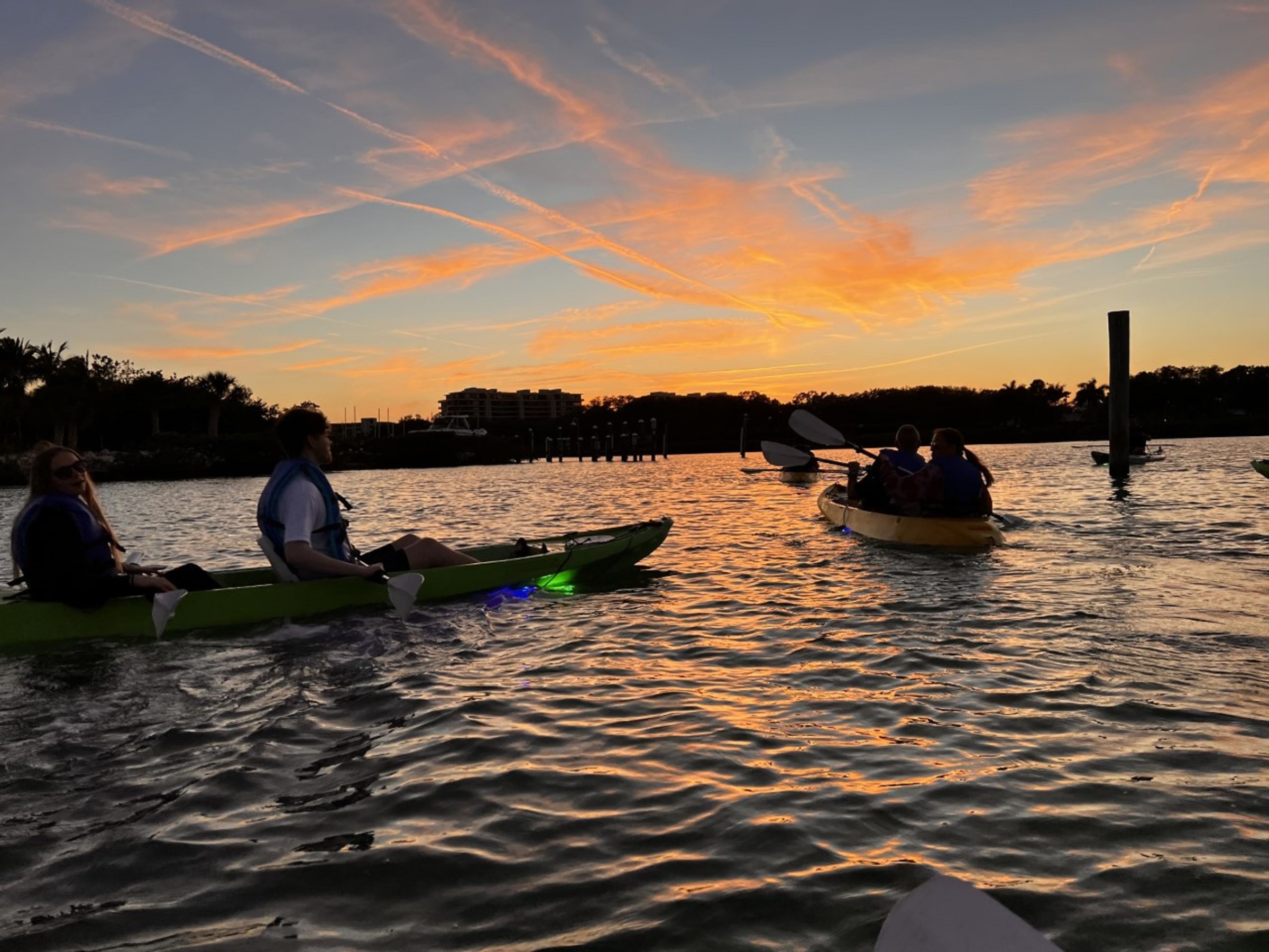 a group of people in a boat on a body of water