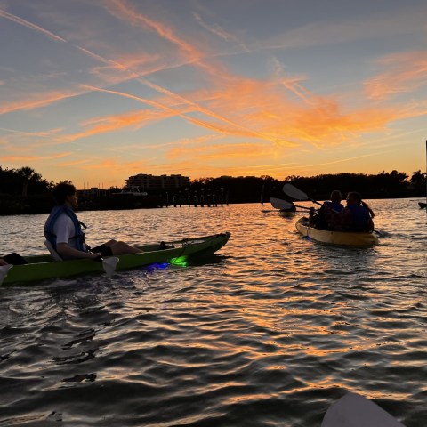 a group of people in a boat on a body of water