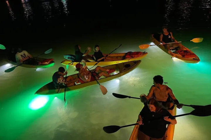 a couple of people that are standing in the water