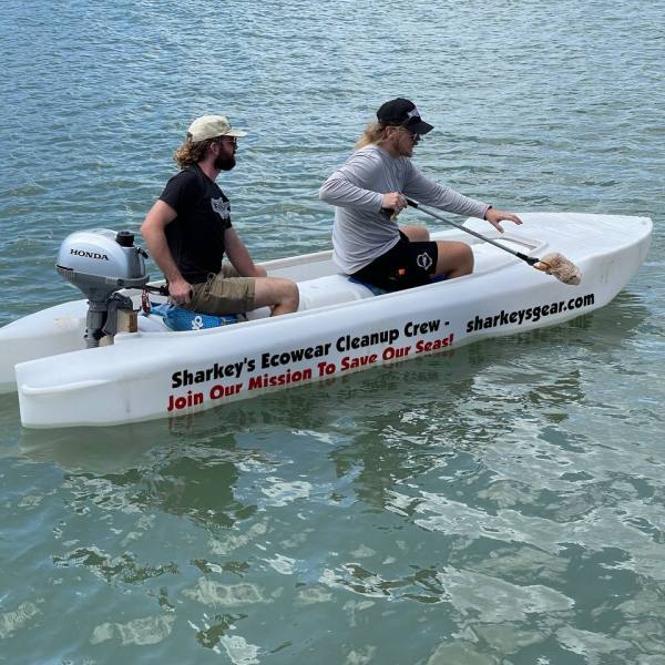 a group of people riding on the back of a boat in the water