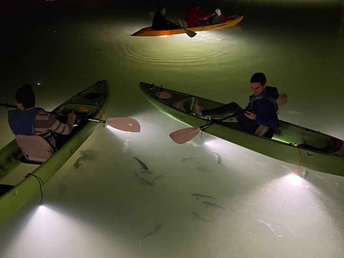 a group of people on a boat in the water