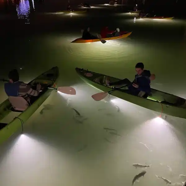 a group of people on a boat in the water