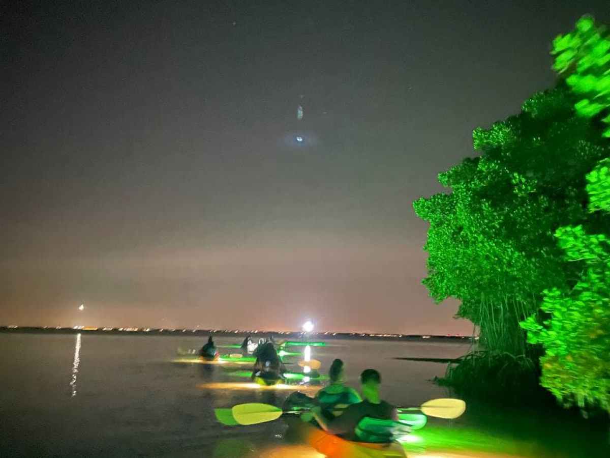 a man standing next to a body of water