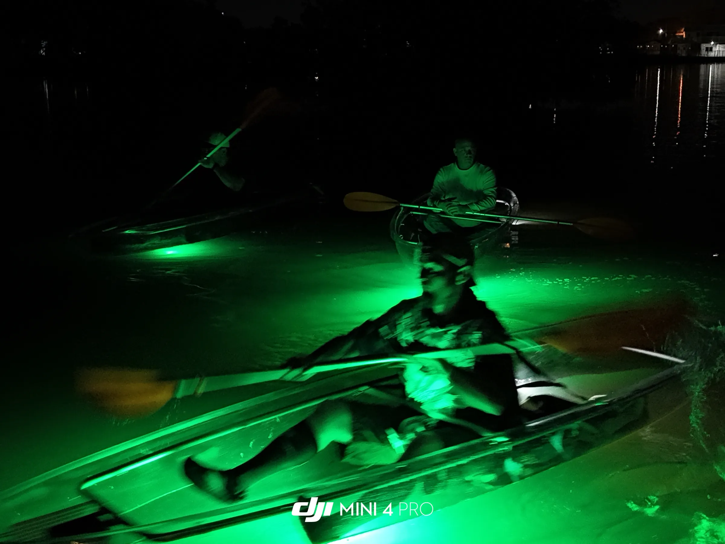 People in a kayak on sharkey's glass bottom night tour