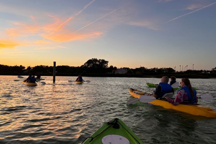 a group of people in a boat on a body of water