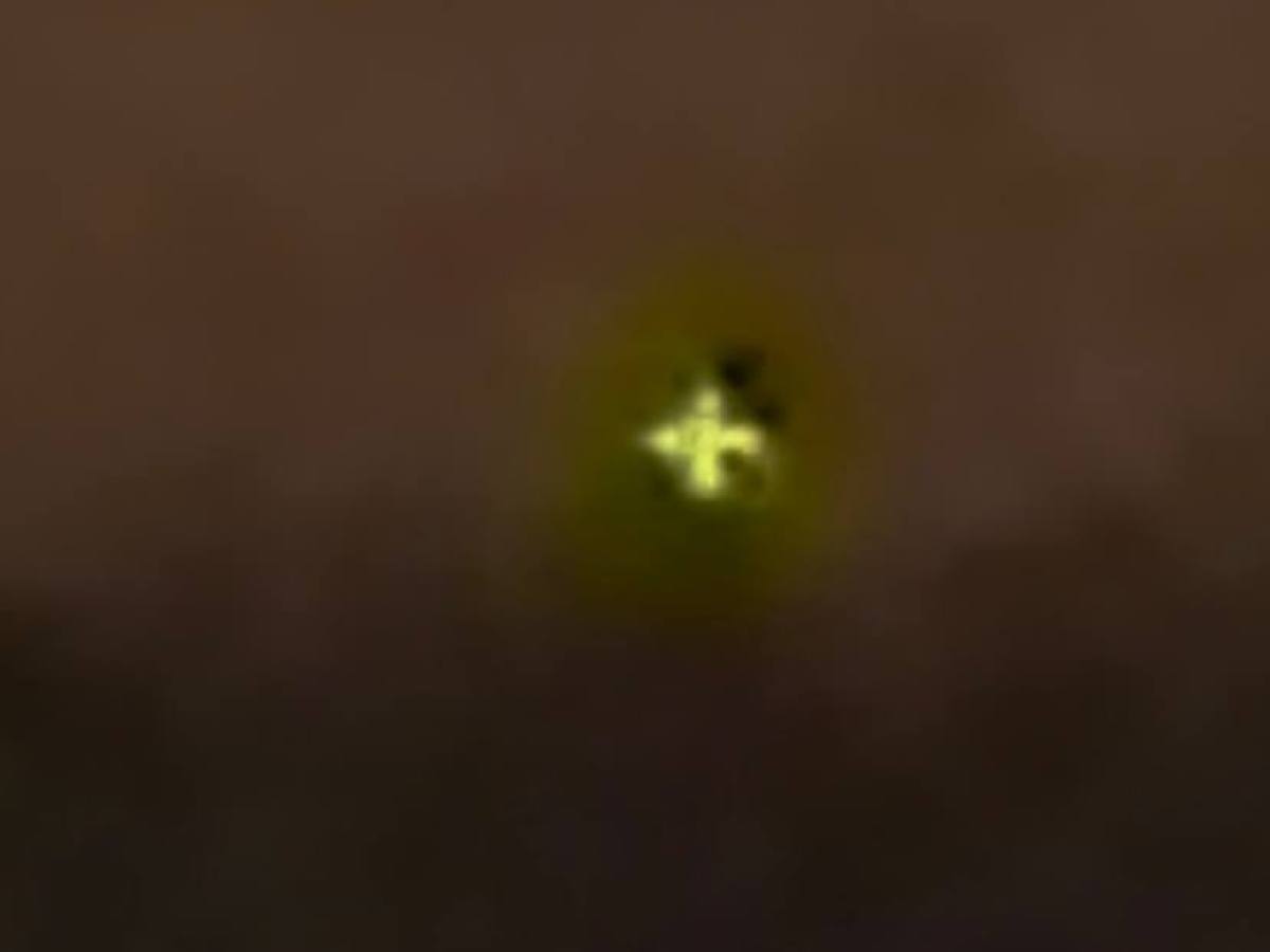 Bright green cross on dark background