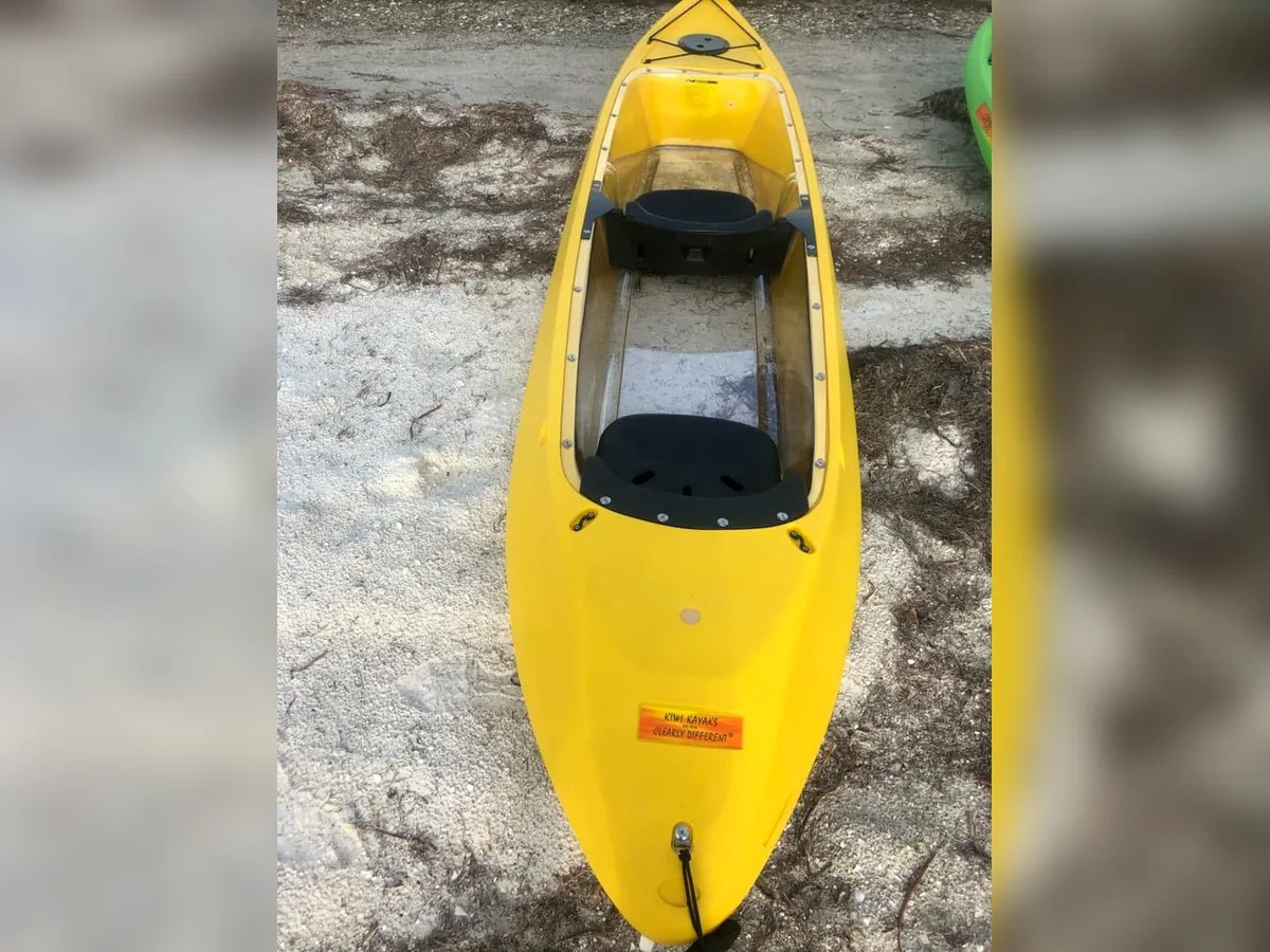 Yellow kayak on a rocky surface, viewed from above.